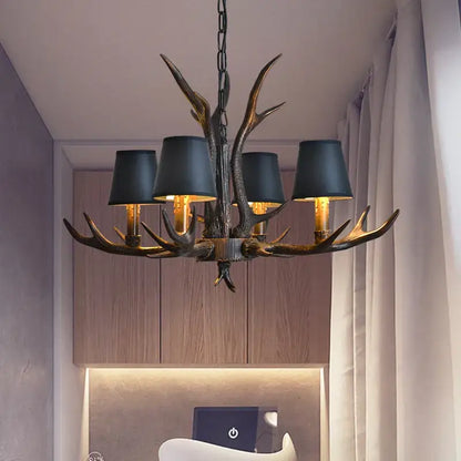 Decorbites antler chandelier with dark bronze finish and black lampshades for rustic bedroom and dining room lighting