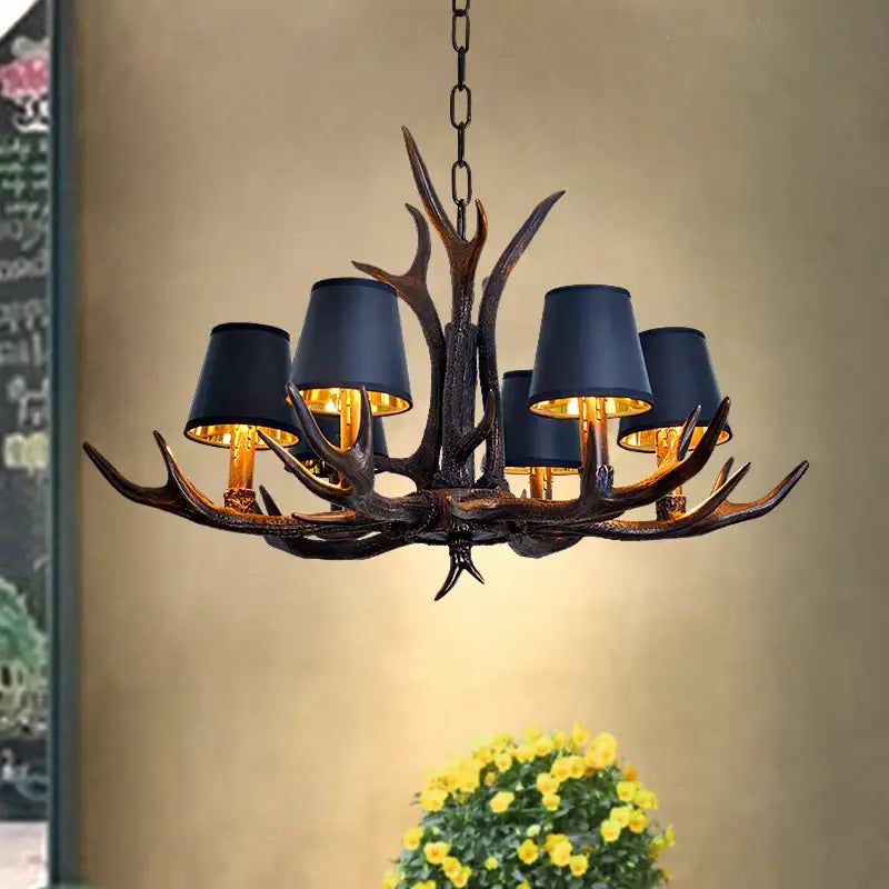 Decorbites antler chandelier with dark bronze finish and five black lampshades for rustic bedroom and dining room lighting