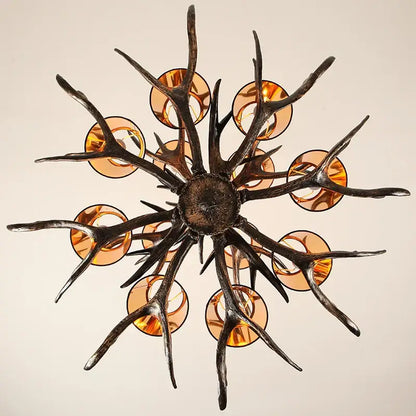DecorBites antler chandelier with dark rustic metal arms and amber glass shades for vintage restaurant cafe decor