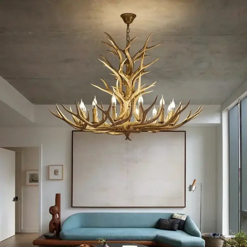 Golden decorbites antler deer chandelier with multiple candle-style bulbs made of rustic resin for living room and loft