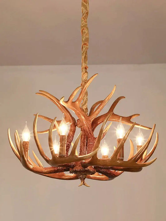 Golden six-arm antler pendant chandelier with lit candle-style bulbs for living room decor by decorbites antler pendant