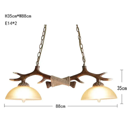Decorbites antler resin chandelier featuring two warm glass shades and rustic brown finish suspended by metal chains