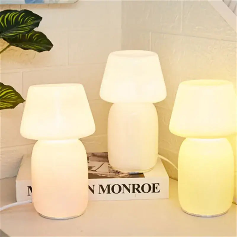 Three decorbites apollo mushroom glass table lamps with frosted white glass shades emitting soft warm light