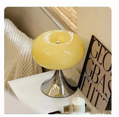 A sleek decorbites apple green table lamp with a glossy yellow dome shade and polished chrome trumpet base