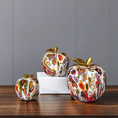 Three vibrant decorbites apple resin figures with floral patterns and gold-toned stems for home office decor