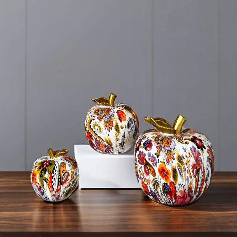 Three vibrant decorbites apple resin figures with floral patterns and gold-toned stems for home office decor