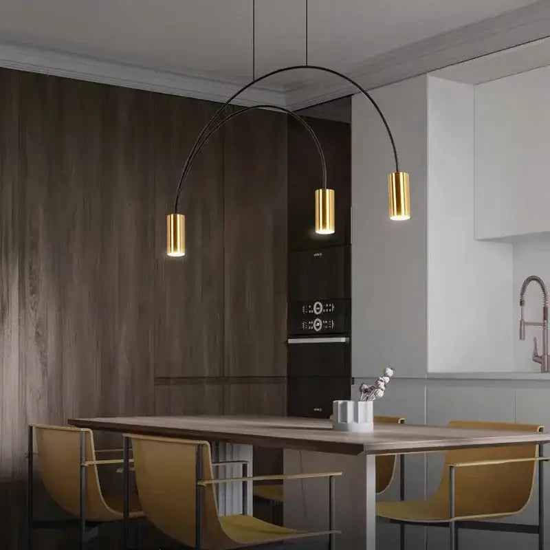 Modern DecorBites Arc pendant light chandelier with three gold cylindrical shades and black metal arms for kitchen island lighting