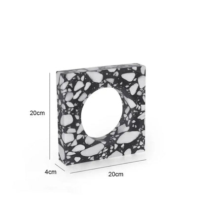 A sleek 20cm square black and white pebble terrazzo sculpture with central circular opening decorbites archway terrazzo