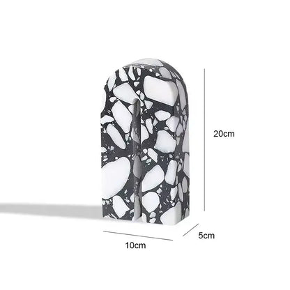 A sleek 20cm tall black and white terrazzo sculpture with a smooth arch design for decorbites archway terrazzo decor