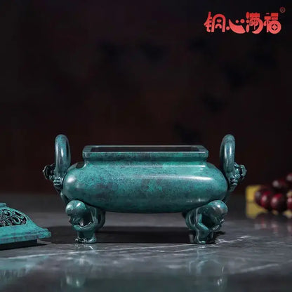 A jade-green decorbites aromatherapy brass incense stove with dragon handles and rectangular top opening for home use