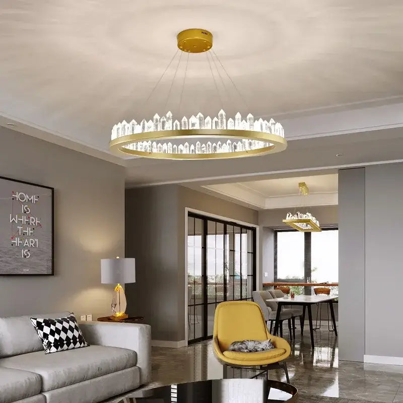 Gold-toned DecorBites Arrow Crystal LED chandelier with clear crystal accents in a circular ring for modern home lighting