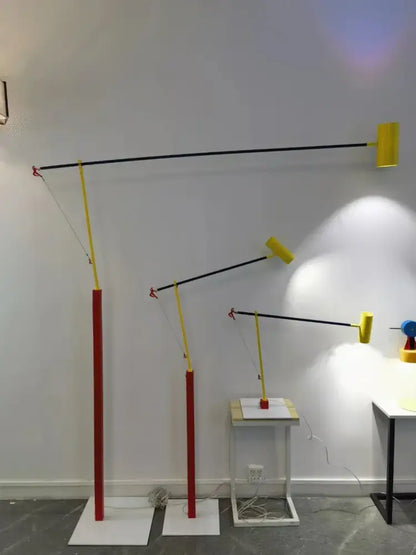 Set of three DecorBites Art Deco colorful metal floor lamps with red bases black articulated arms and yellow shades