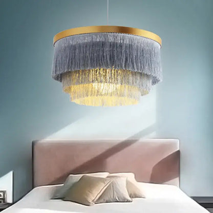 DecorBites Art Deco tiered chandelier with gold-toned frame and cascading gray and golden cotton thread fringes