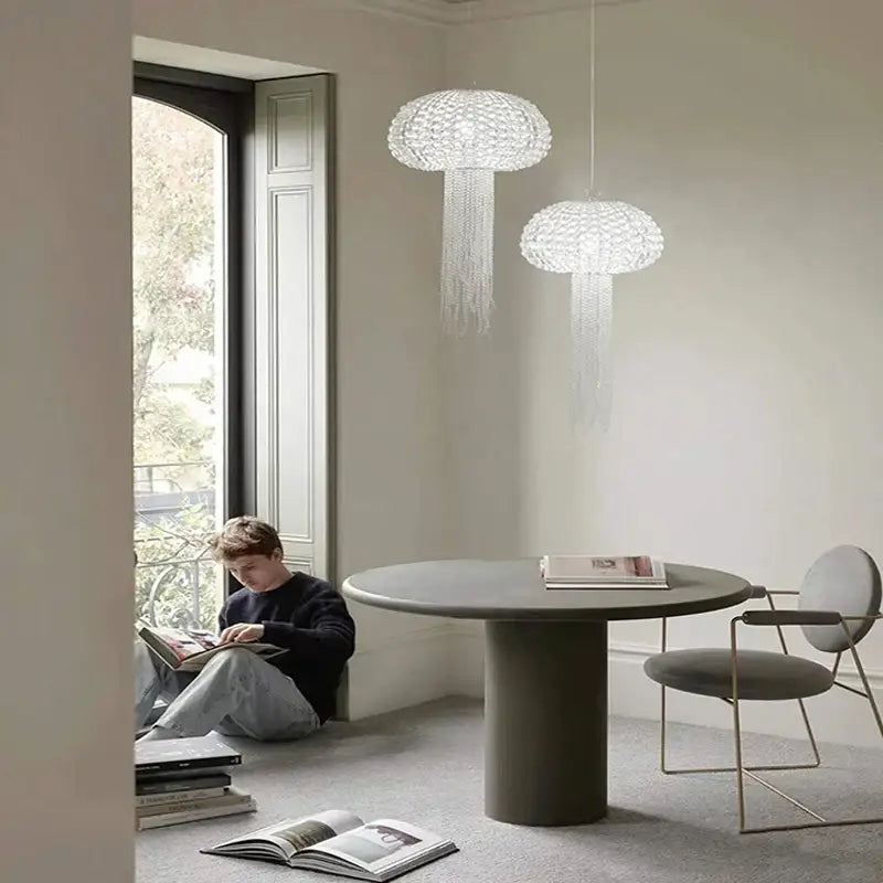 Two elegant translucent white DecorBites art deco dimmable jellyfish pendant lights with crystal strands hanging