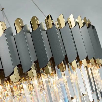 A modern pendant light with matte black and gold panels and hanging crystal prisms from decorbites art deco