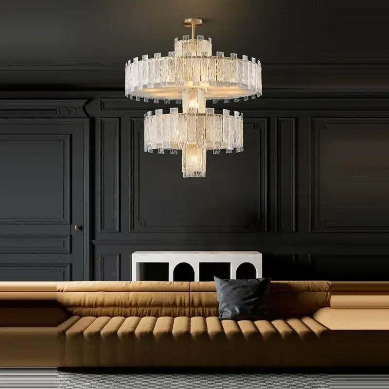 A multi-tiered decorbites art deco golden copper chandelier with cascading clear glass rods and led lighting fixture