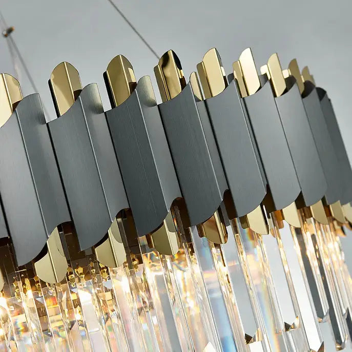 A decorbites art deco golden crystal chandelier featuring matte black and gold panels with hanging crystal prisms