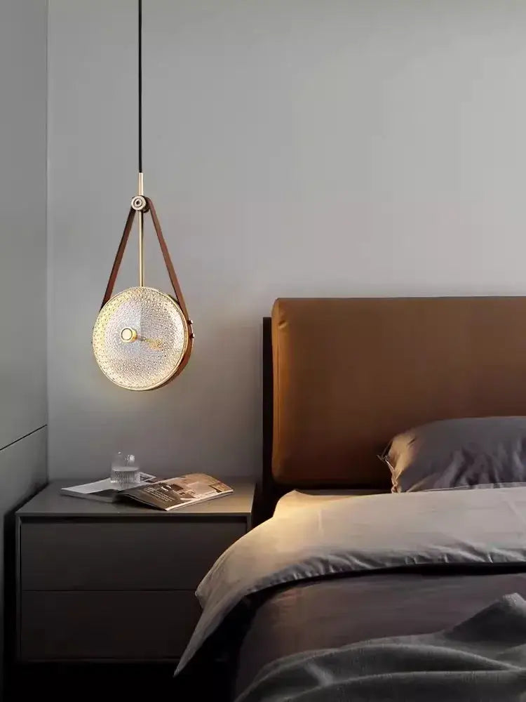 Decorbites art deco pendant light with circular textured glass shade, brown leather straps, and brass hardware