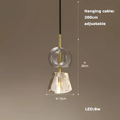A modern DecorBites art deco pendant light with clear faceted crystal shade and gold-toned metal accents