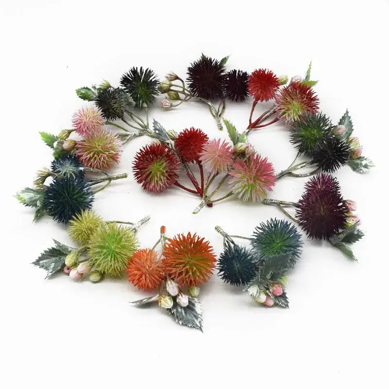 A collection of vibrant red pink orange green and black decorbites artificial grass plants with spiky thistle heads for home decor