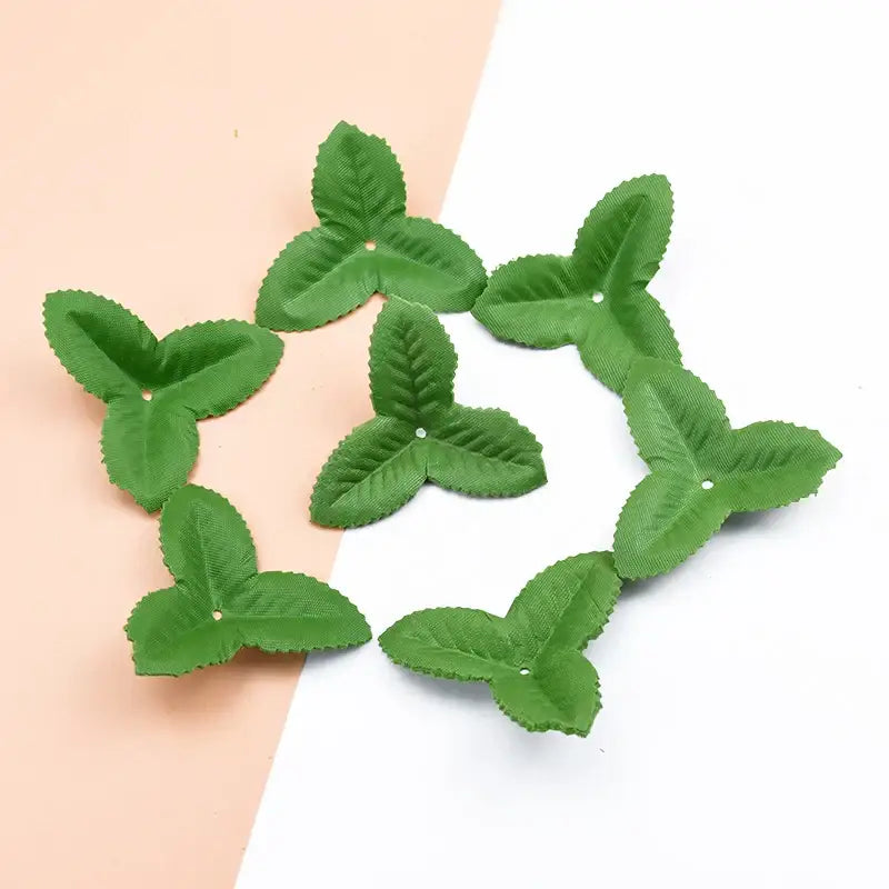 Green three-leaf fabric flower embellishments with stitched veins and metallic eyelets for decorbites artificial green silk roses