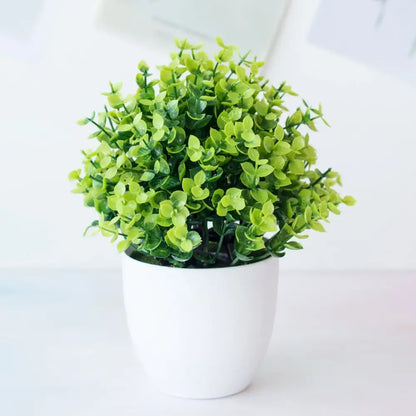 A decorbites artificial mini green plant bonsai with dense foliage in a white ceramic pot for desktop decor