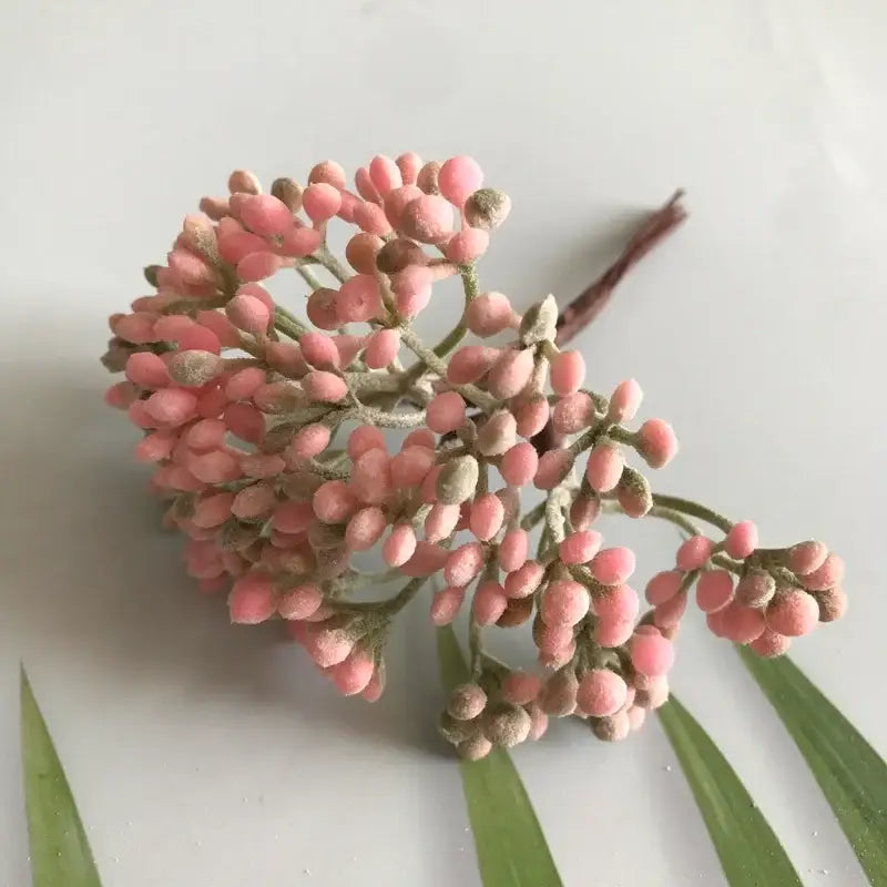 A cluster of pink frosted artificial berries on a green stem from decorbites artificial plants dried plants diy garland craft