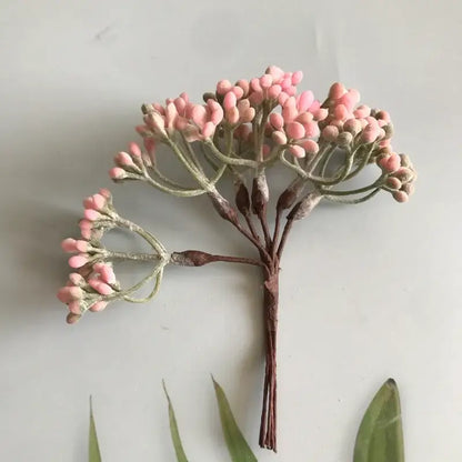 A delicate cluster of pink frosted artificial berries with brown stems from decorbites artificial plants diy dried plants collection
