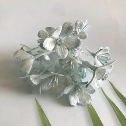 A cluster of silver-frosted artificial plants with delicate petals in decorbites artificial plants green grass decor