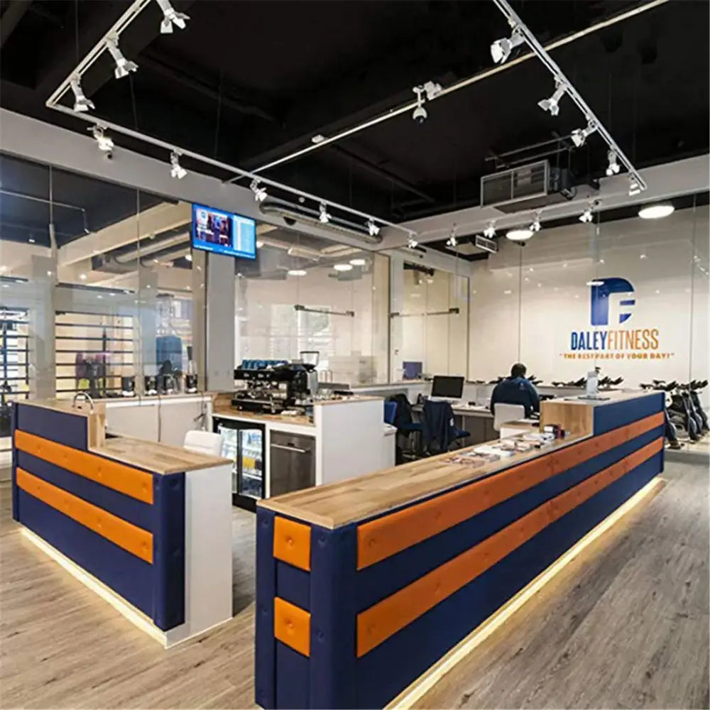Modern reception desk with navy blue and orange striped panels, wooden countertop, and decorbites artwork led track lighting fixture