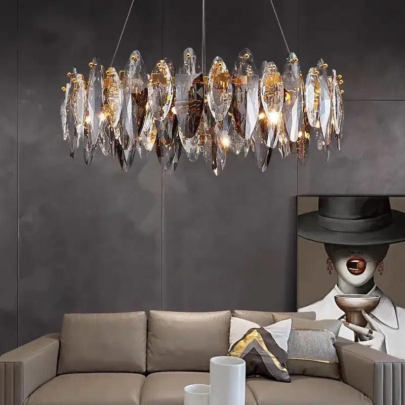 A modern decorbites ash crystal ceiling chandelier with clear faceted crystal shards and gold-toned metal accents