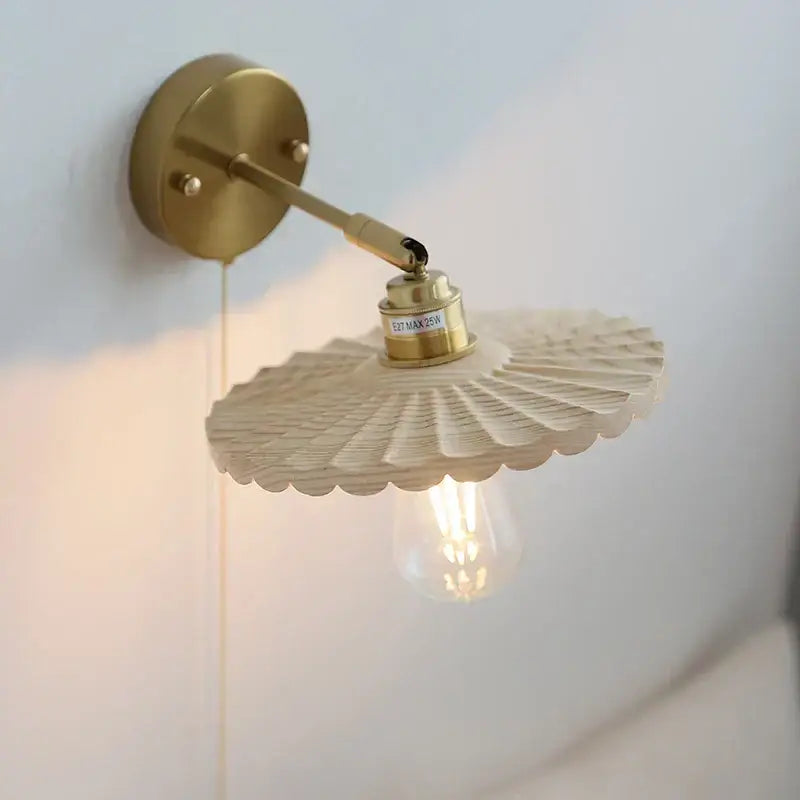 A brass-finished decorbites ash wood led wall sconce with a fan-shaped wooden shade and exposed Edison bulb