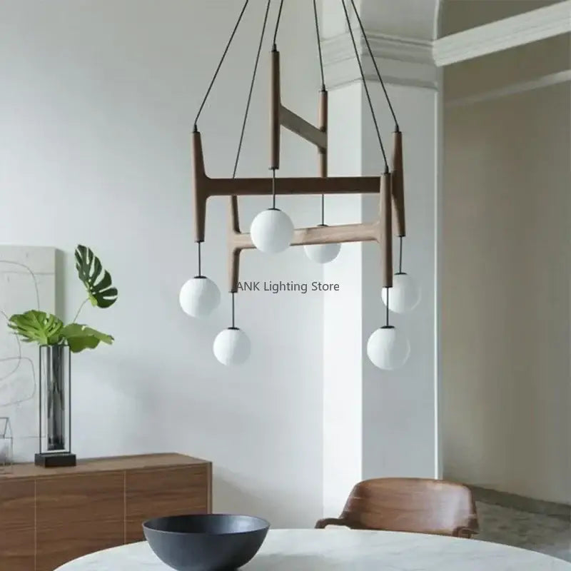 Modern wooden chandelier featuring five white spherical glass globes by DecorBites ASTRA wood pendant light