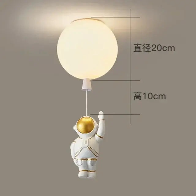 White astronaut figurine with gold accents holding glowing light in decorbites astronaut balloon ceiling lamp for kids room