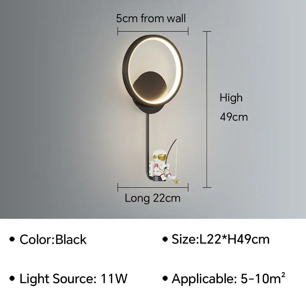 Black modern wall lamp with circular LED ring and hanging astronaut cartoon figurine decorbites astronaut cartoon