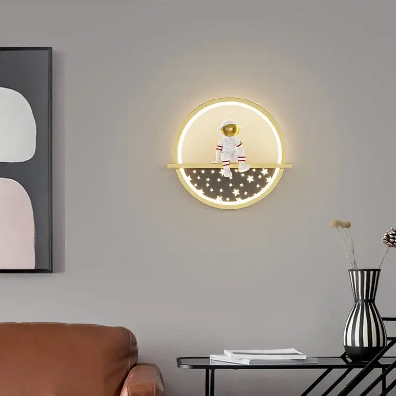 Decorbites astronaut cartoon led wall lamp with glowing circular light and white astronaut figurine on golden ledge