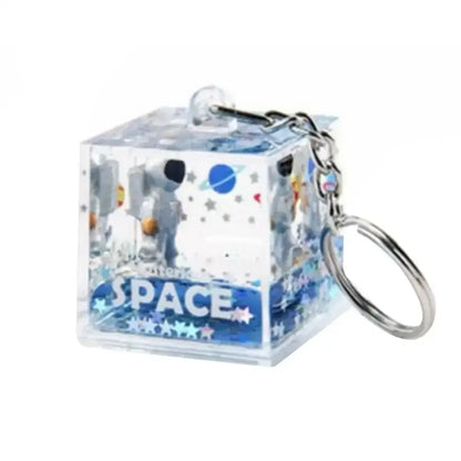 Clear cube keychain with liquid-filled resin and space-themed astronaut drift design from decorbites astronaut drift collection