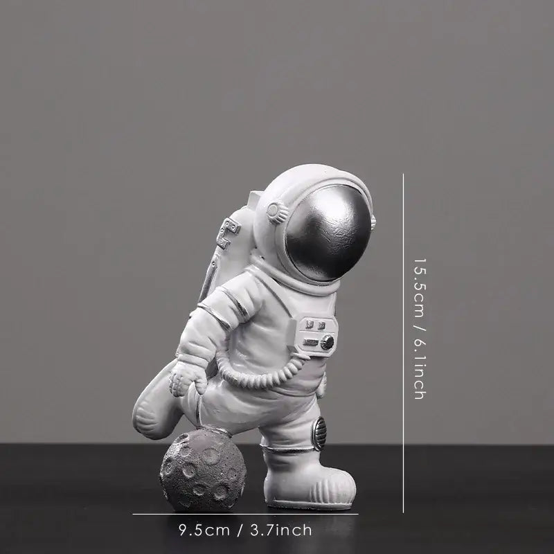Decorbites astronaut figurine abstract sculpture features a white figure with metallic silver helmet on gray moon surface
