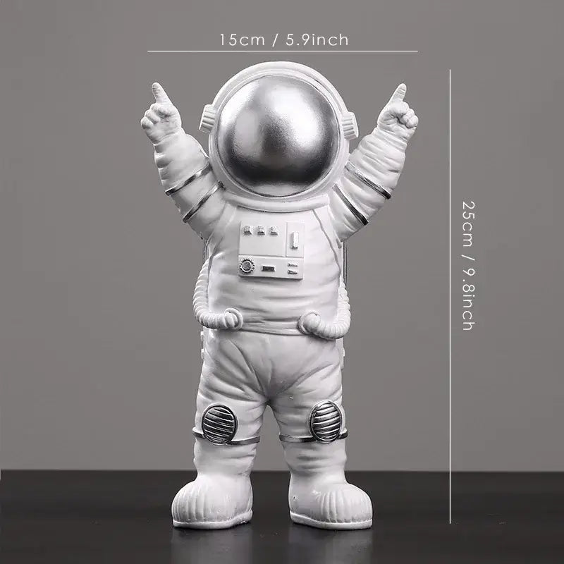 A sleek silver-toned decorbites astronaut figurine abstract sculpture with a glossy helmet and detailed suit for modern decor