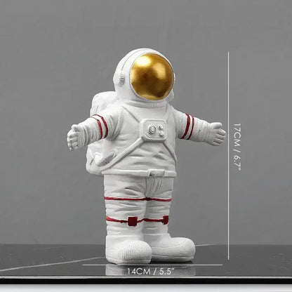 White astronaut figurine with gold visor and red accents in welcoming pose from DecorBites astronaut figurines collection