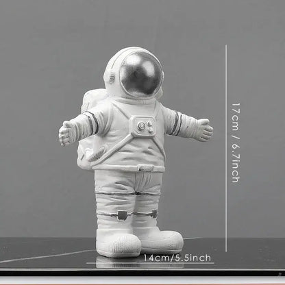 White astronaut figurine with reflective silver helmet and detailed suit on dark surface from decorbites astronaut figurines collection