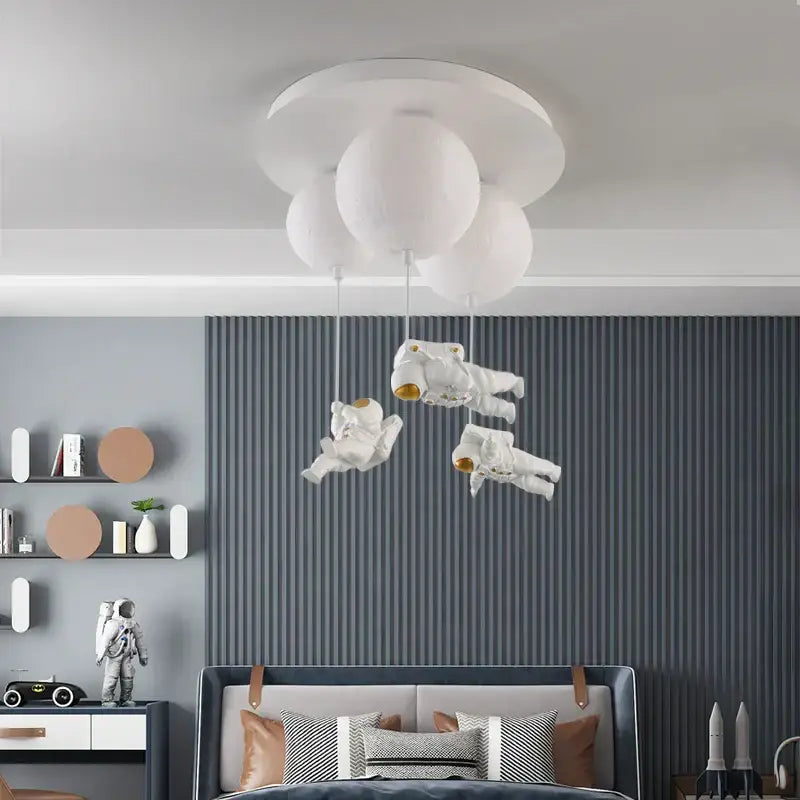 White cloud-shaped ceiling light with three suspended astronaut figures decorbites astronaut globe ceiling light for kids room