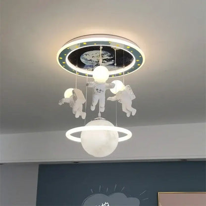 DecorBites astronaut led ceiling light featuring three white astronaut figures above glowing moon with planet backdrop