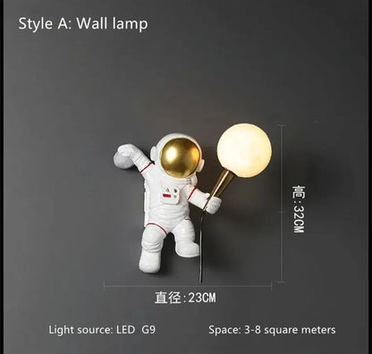 White resin decorbites astronaut led desk lamp with gold helmet holding a glowing spherical light fixture