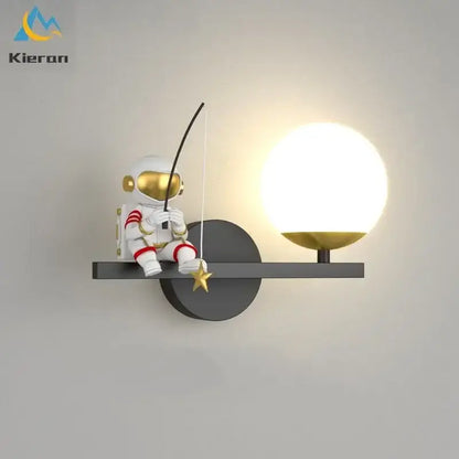 White astronaut figurine with gold accents and red stripes seated beside a glowing lamp in decorbites astronaut led wall lamps