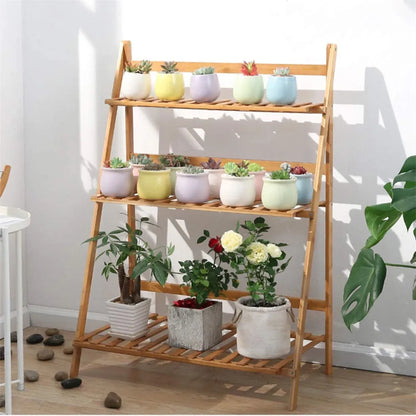 Light brown bamboo decorbites 3 tier shelf stand with colorful ceramic pots on each plant pot shelf