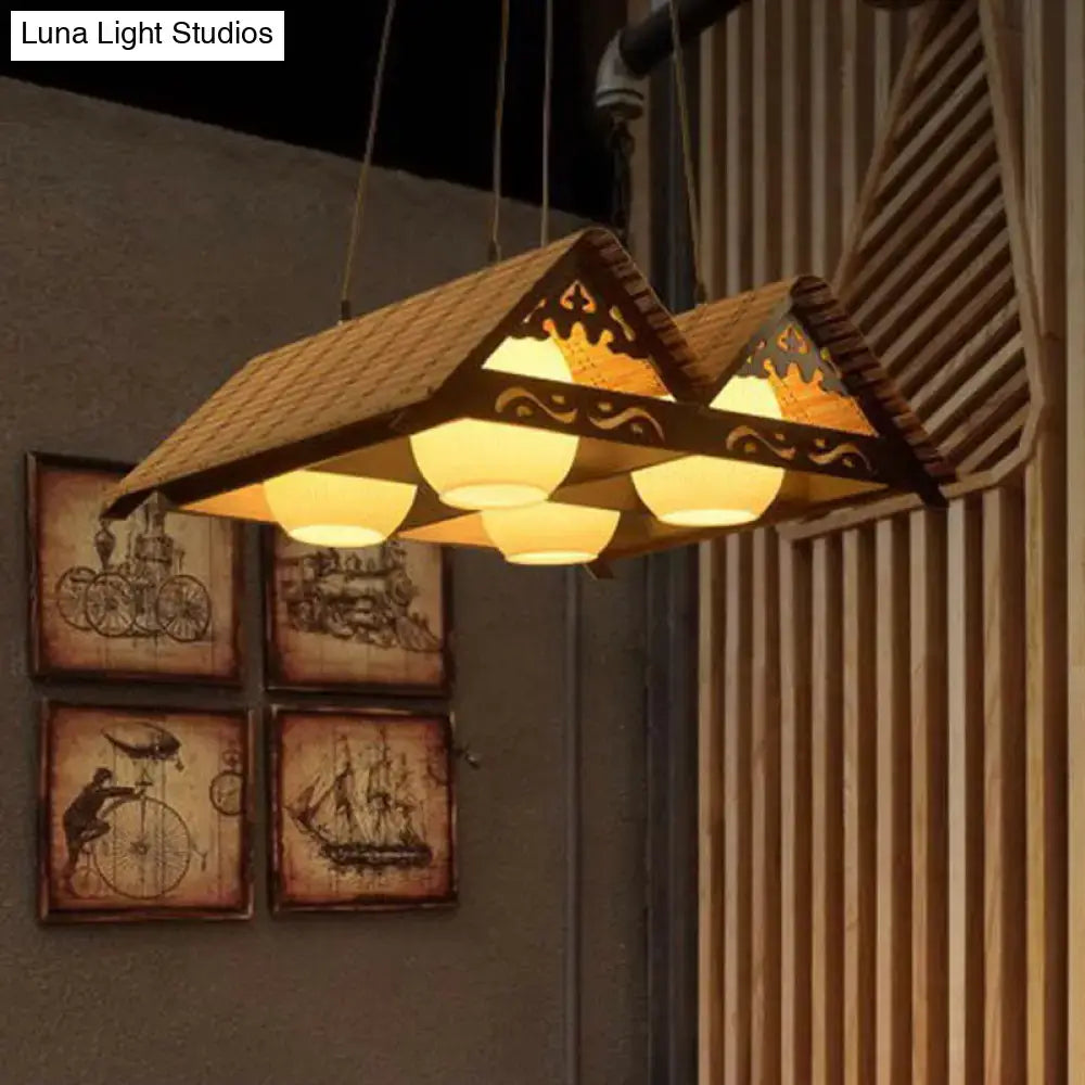 Rustic bamboo pendant light with four warm glass globes and cutouts for triangle roof restaurant decorBites design