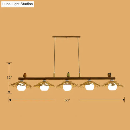 Decorbites bamboo pendant lighting featuring rustic wooden beam with five white glass globe bulbs and art deco bird accents