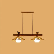 Rustic wooden bamboo pendant lighting with white glass shades and bird figurines in art deco style