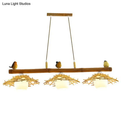 Natural bamboo pendant lighting with three woven nest shades and white glass art deco bird figurines by DecorBites